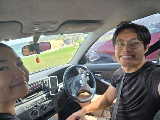 Toan and I inside the car in front of Bar Beach.